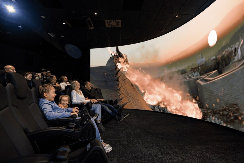 A movie theater with people watching a film. 1