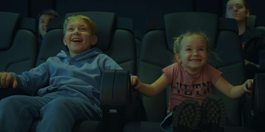 Two children seated in a movie theater. 5