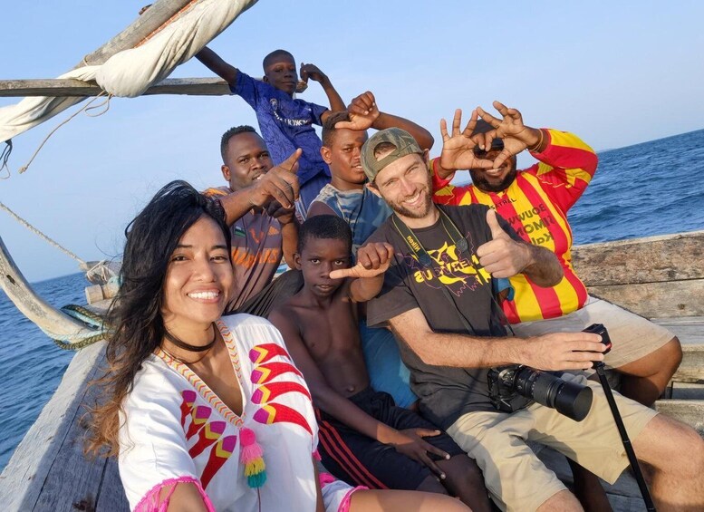 A group of people on a boat with the ocean in the background. 5