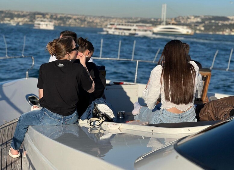 People on a boat with a cityscape and bridge in the background. 3