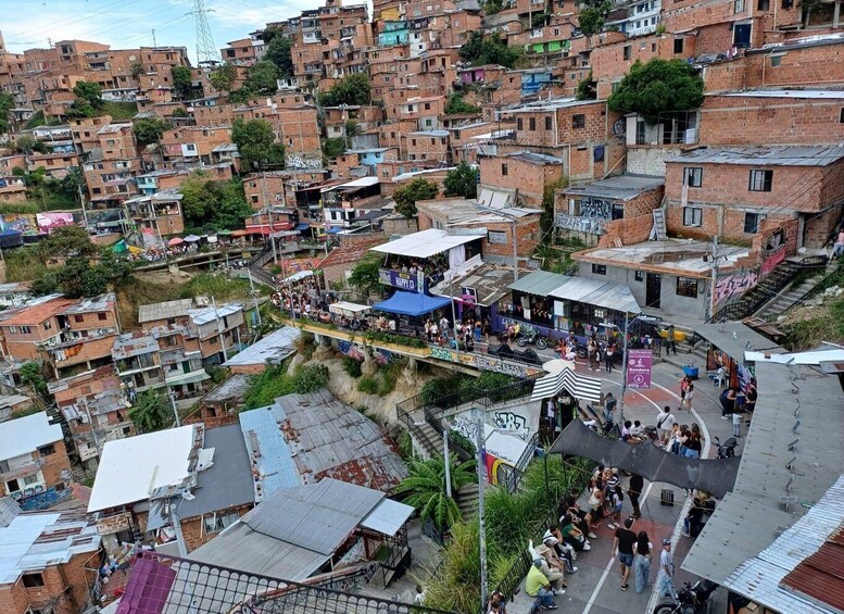 A densely packed urban area with numerous brick buildings, a bustling street with people and vendors, and a prominent blue-roofed structure. 3