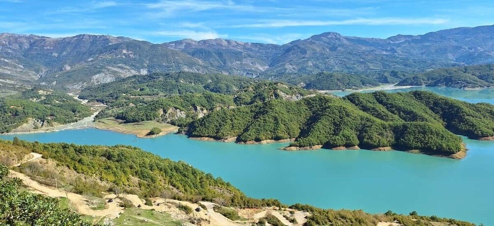 A mountainous landscape with a river and forested areas. 1