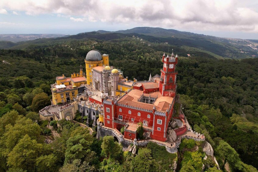 Pena Palace in Sintra, Portugal, surrounded by lush greenery and hills. 2