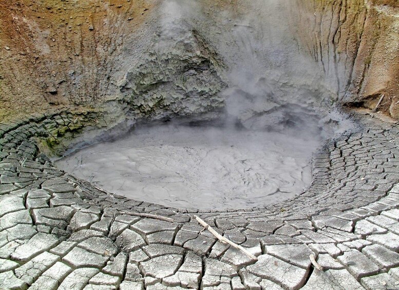 A geothermal area with a crater filled with steam. 1