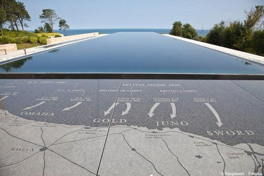 A pool with a map design on the floor, including names like Omaha, Gold, Juno, and Sword. 2