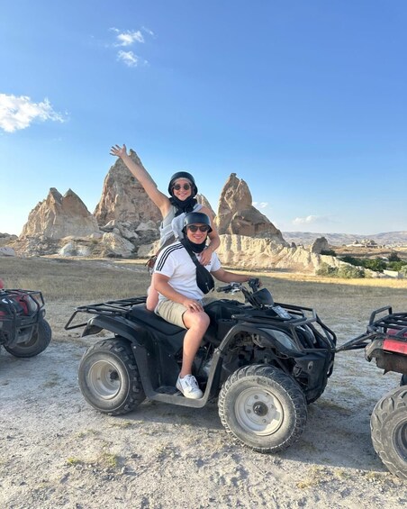 Two people on an ATV in a rocky landscape with distinctive rock formations. 3