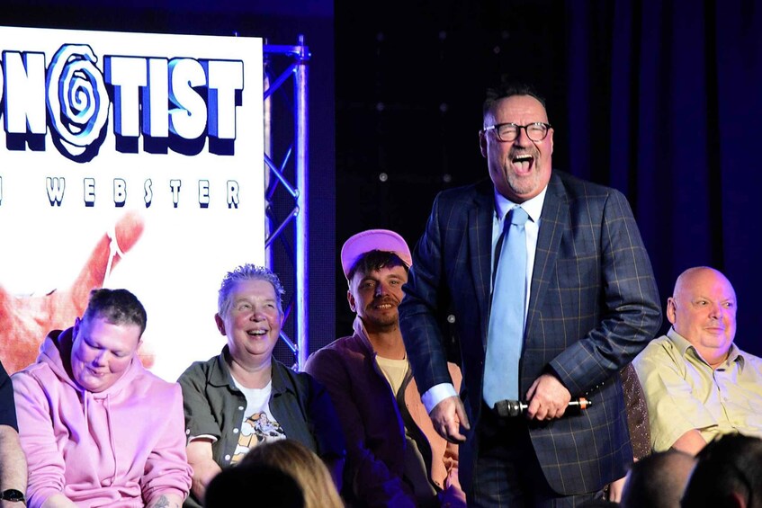 A group of people on a stage with a sign that reads 'NIST WEBSTER'. 4
