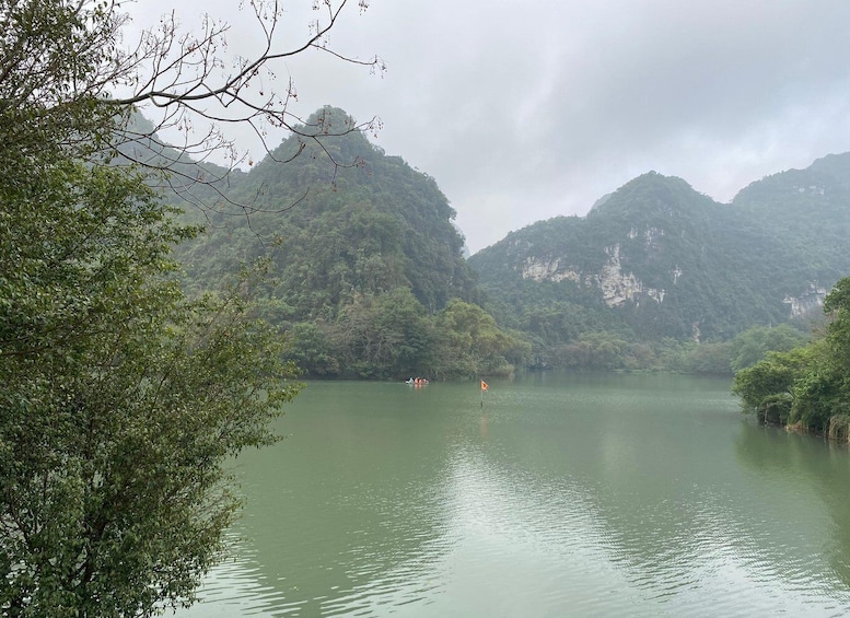 A calm river surrounded by lush green hills. 4