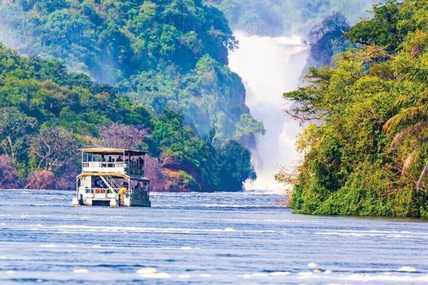 A boat on a river with a waterfall in the background. 2
