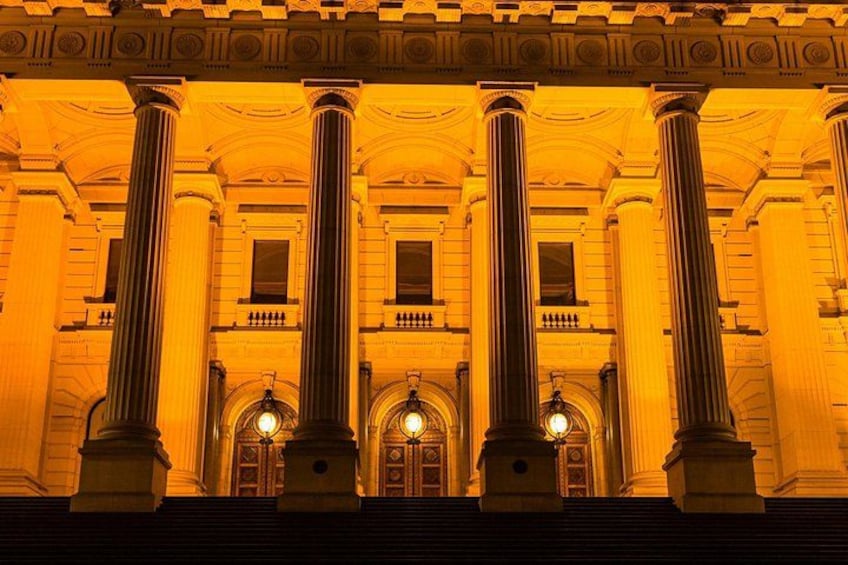 A grand building with large columns and arched doorways. 1