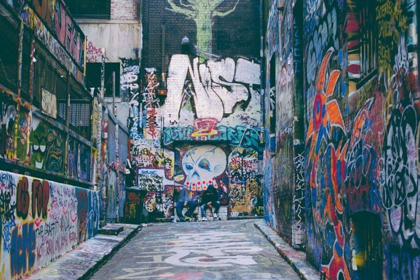 A narrow alley with colorful graffiti on the walls. 5