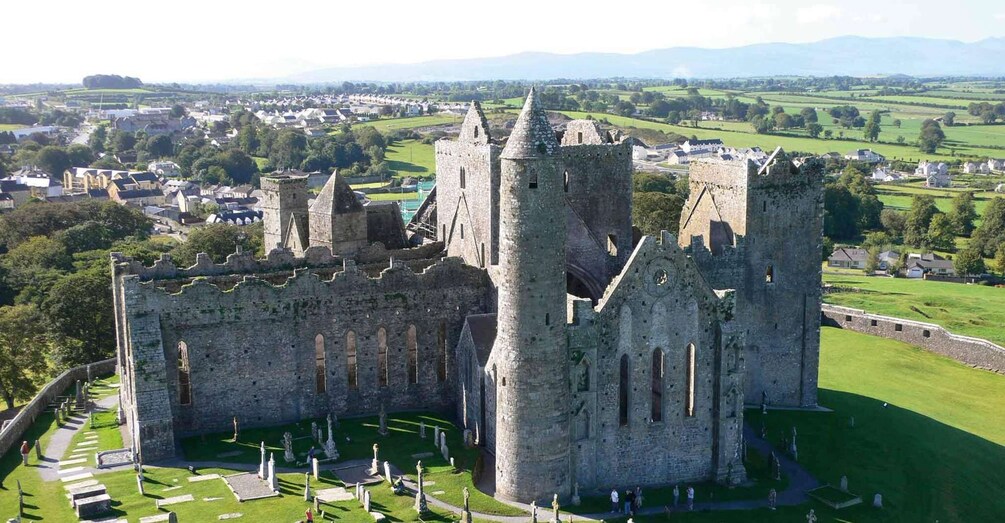 A historic castle with multiple towers and a surrounding graveyard. 1