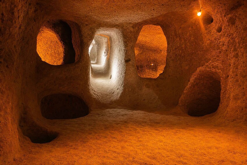 A cave with natural rock formations and a single light source. 4