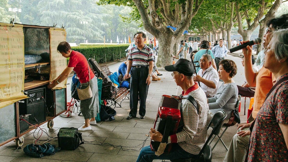 A street musician performing with an accordion, surrounded by onlookers. 5