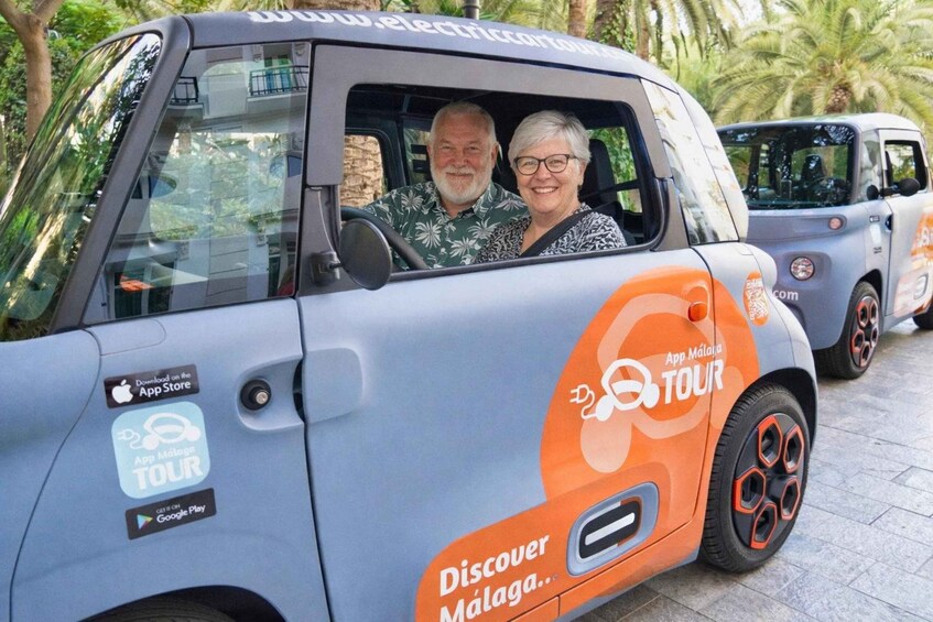 A vehicle with 'Discover Málaga' and 'App Màlaga TOUR' stickers, parked outdoors with palm trees in the background. 4