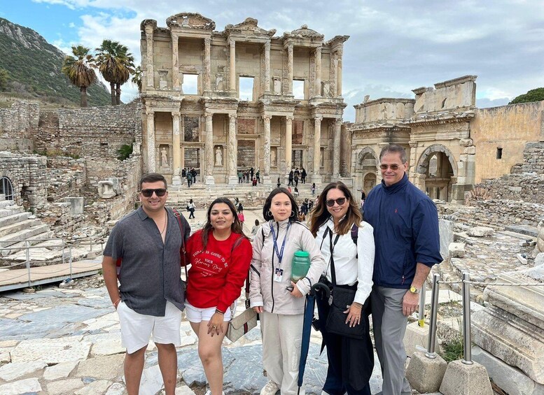 A group of people standing in front of the ancient ruins of the Library of Celsus in Ephesus. 2