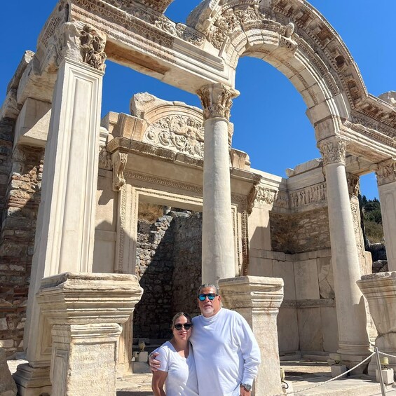 An ancient stone archway with intricate carvings and columns, likely part of a historical site. 2