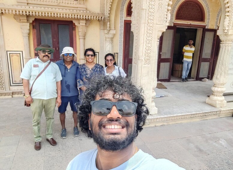 A group of people in front of a building with ornate architecture. 3