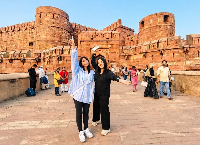 A historic fort with red stone walls and multiple towers. 5