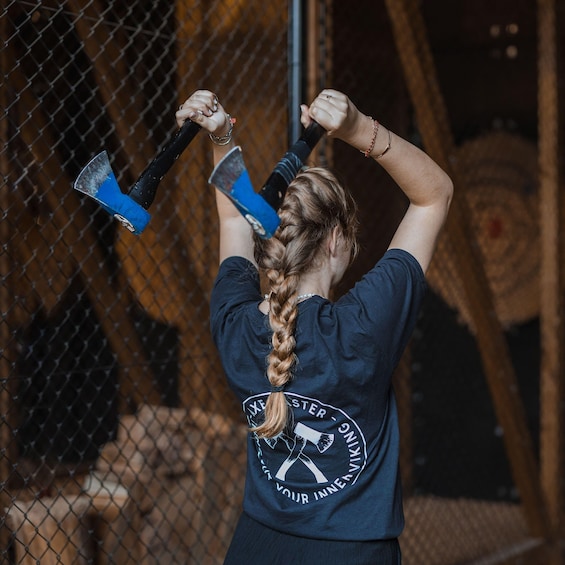 A person with a braided ponytail holding a hammer. 5