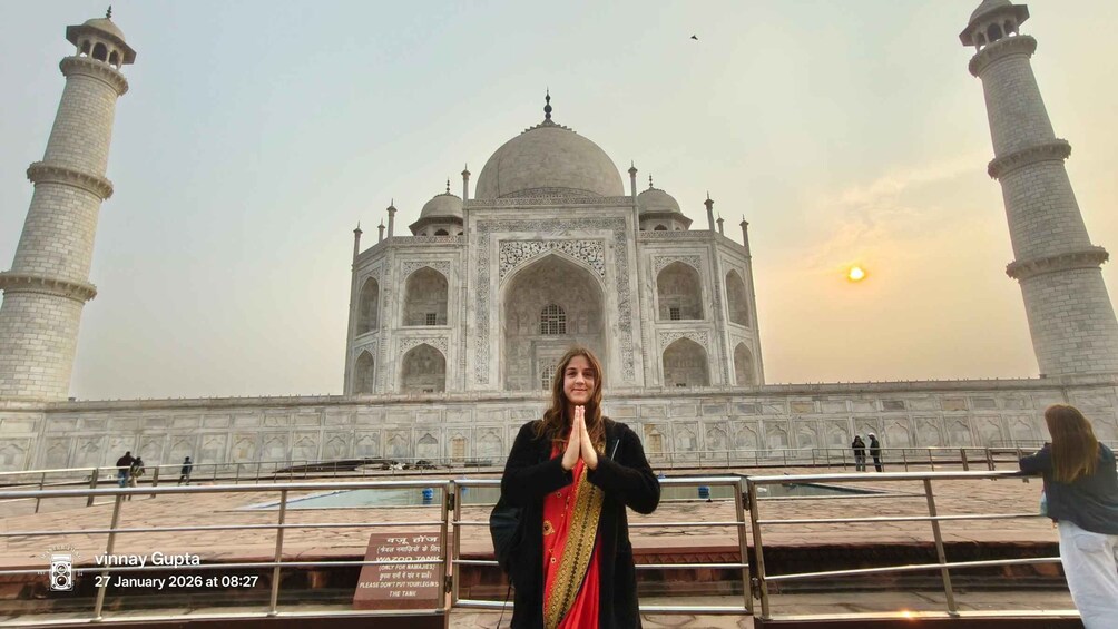 A person in front of the Taj Mahal with a sign in the foreground. 5