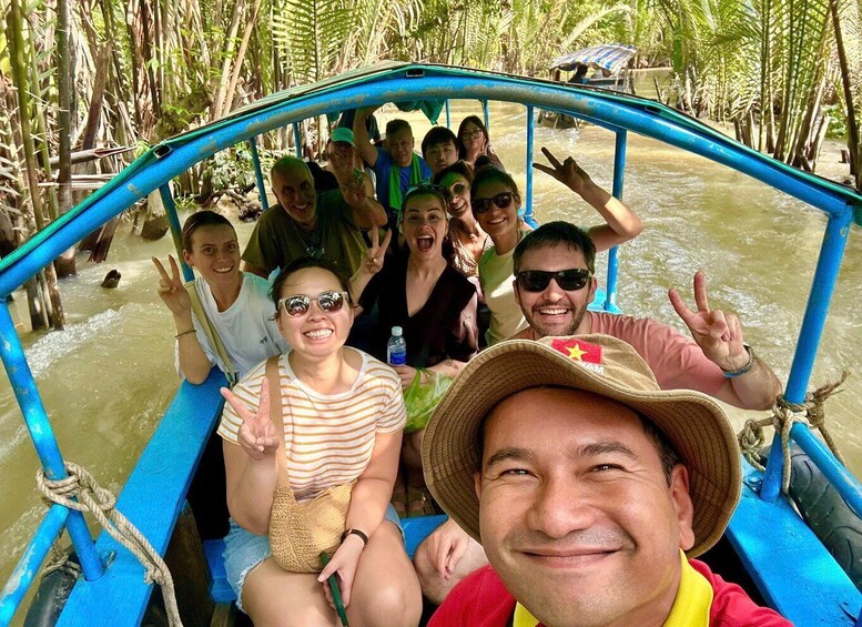 A group of people on a boat in a river surrounded by dense vegetation. 3