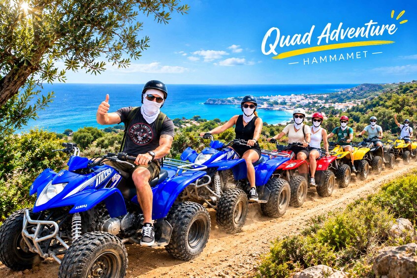 People riding quad bikes on a dirt path with a scenic view of the sea and a town in the background. 1
