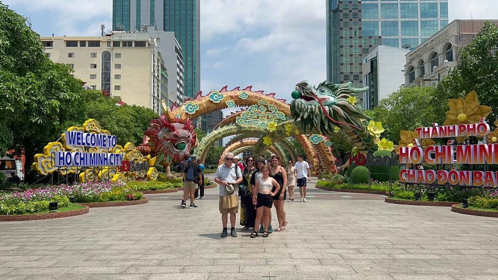 A dragon-shaped archway with people standing underneath it. 1