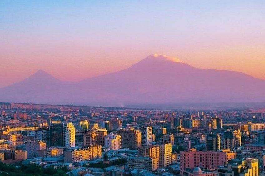 A cityscape with a mountain in the background. 1