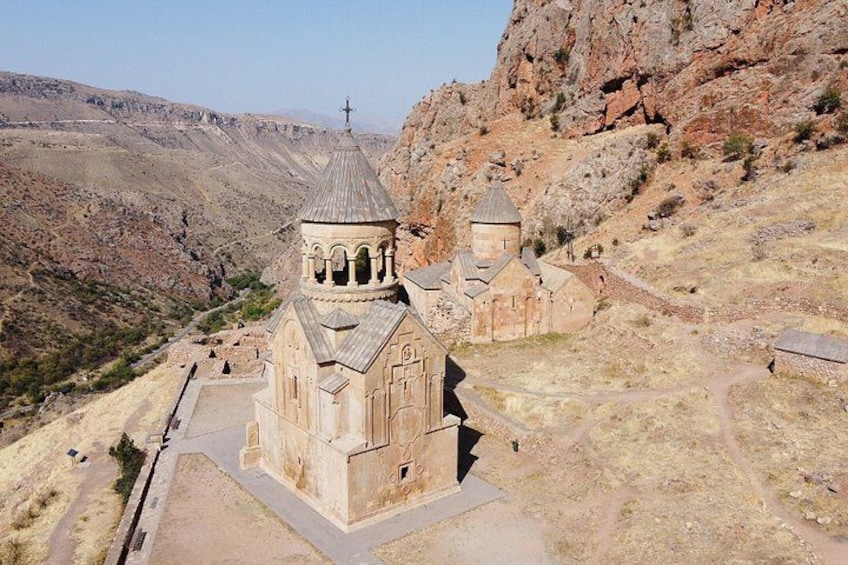 A church with a bell tower and dome, surrounded by a mountainous landscape. 2