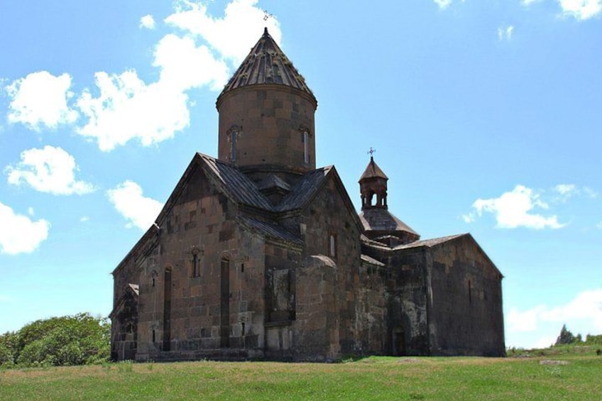 A large, historic church with a prominent bell tower and a smaller bell structure. 3