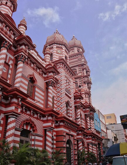 A large, ornate building with red and white striped patterns and multiple domes. 3
