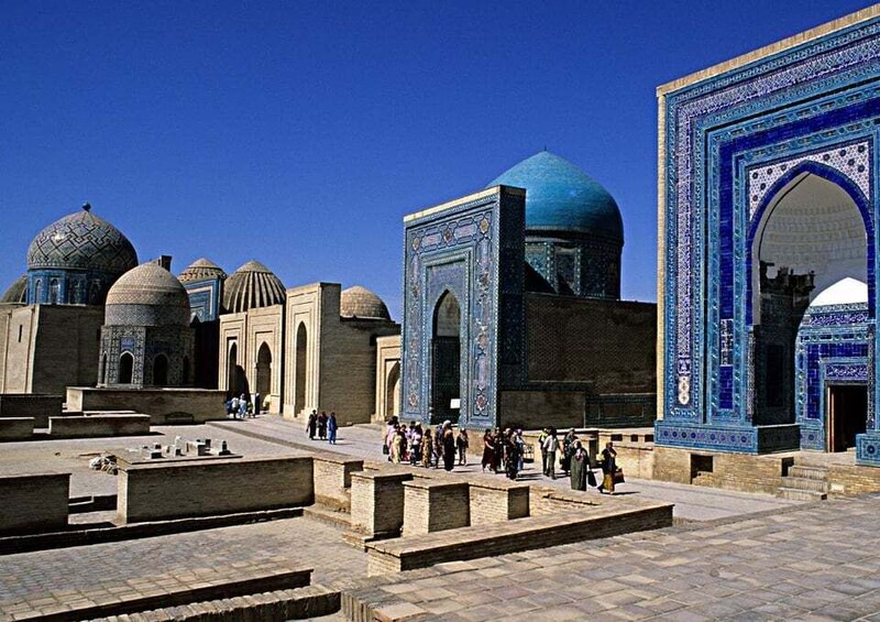 A historic building with domed structures and intricate blue tile work. 3