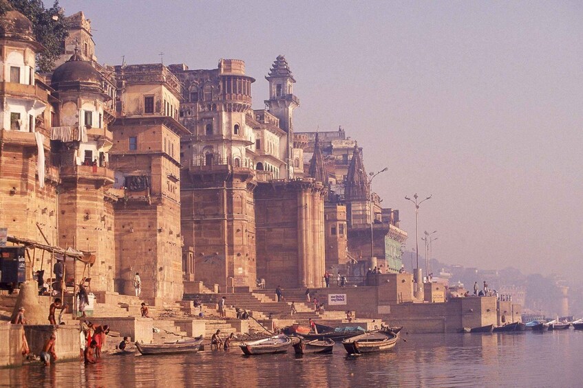 A riverside cityscape with historic buildings and boats. 4