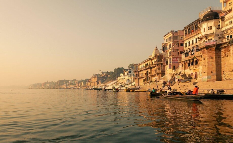A riverside view with boats and buildings along the bank. 2