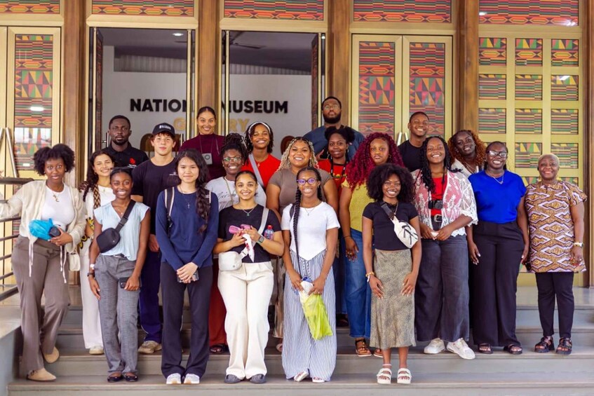 A group of people standing in front of a building with a sign that reads "NATIONMUSEUM". 5