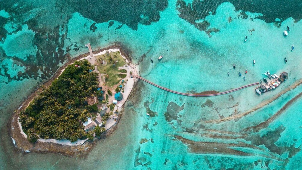 An aerial view of a tropical island with a bridge connecting it to the mainland. 5