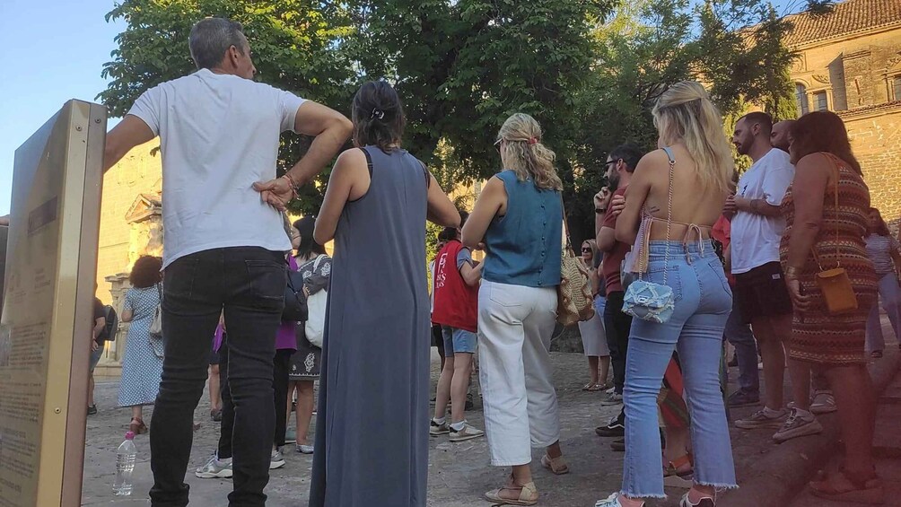 A group of people standing in a line outdoors, possibly at a public event or gathering. 2