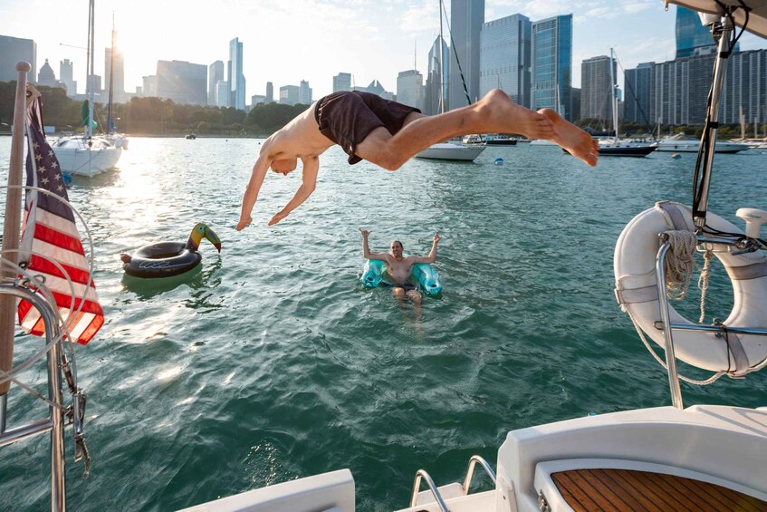 A person diving into the water from a boat with a city skyline in the background. 5