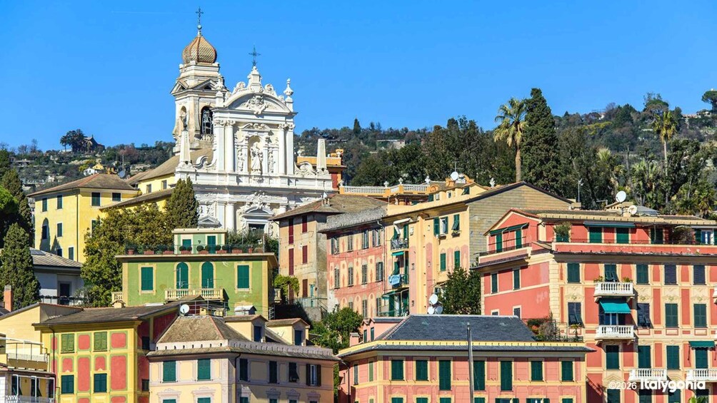 A historic church with ornate architecture, colorful buildings, and a clear blue sky. 3
