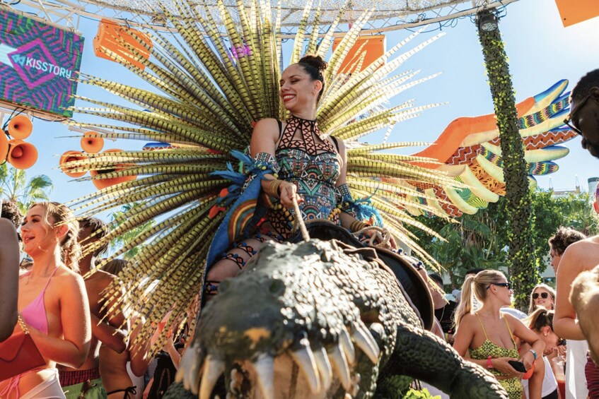 A person riding a decorated elephant at a festival. 2