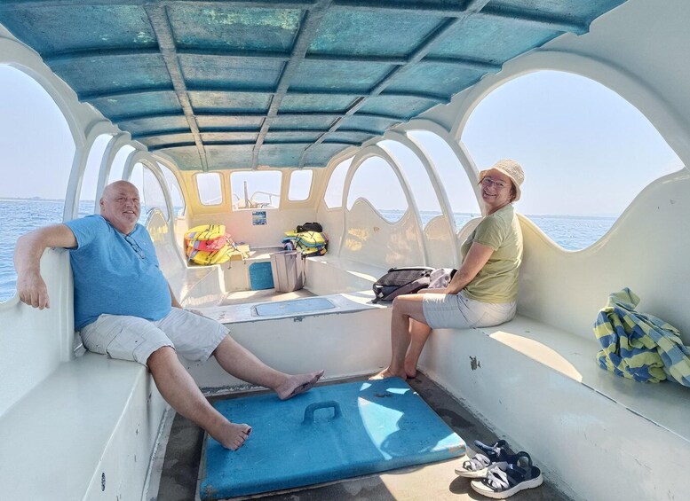 Two people on a boat with a blue mat and life jackets. 5