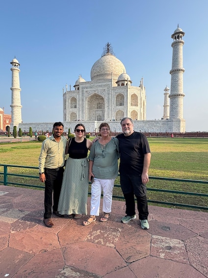 A group of people standing in front of the Taj Mahal. 4