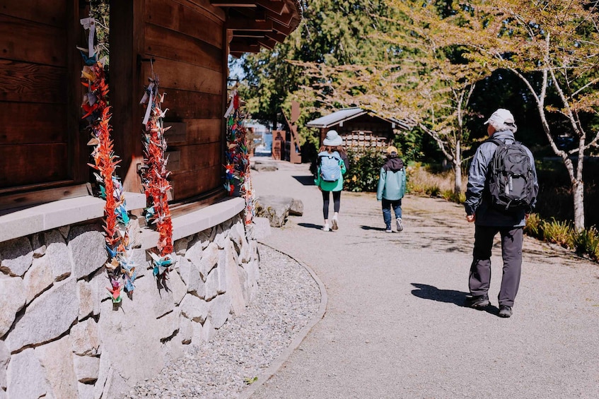A wooden building with decorative garlands, a paved path, and a person walking. 2