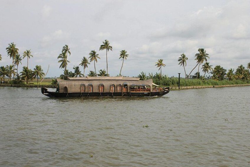 A houseboat on water with palm trees in the background. 5