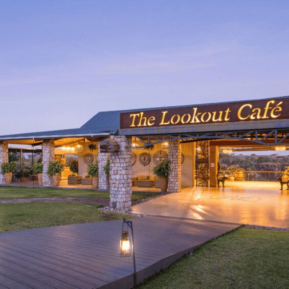 The Lookout Café with outdoor seating and a stone pillar. 1