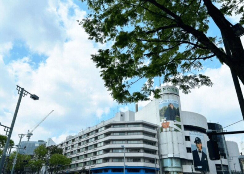 A multi-story building with a prominent advertisement featuring a man in a suit. 5