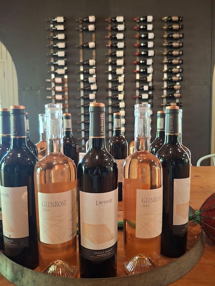 A selection of wine bottles on a table with a backdrop of wine racks. 5