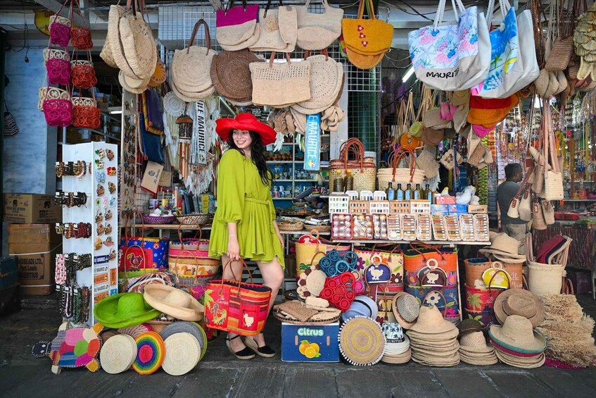 A market stall with various bags and hats. 2