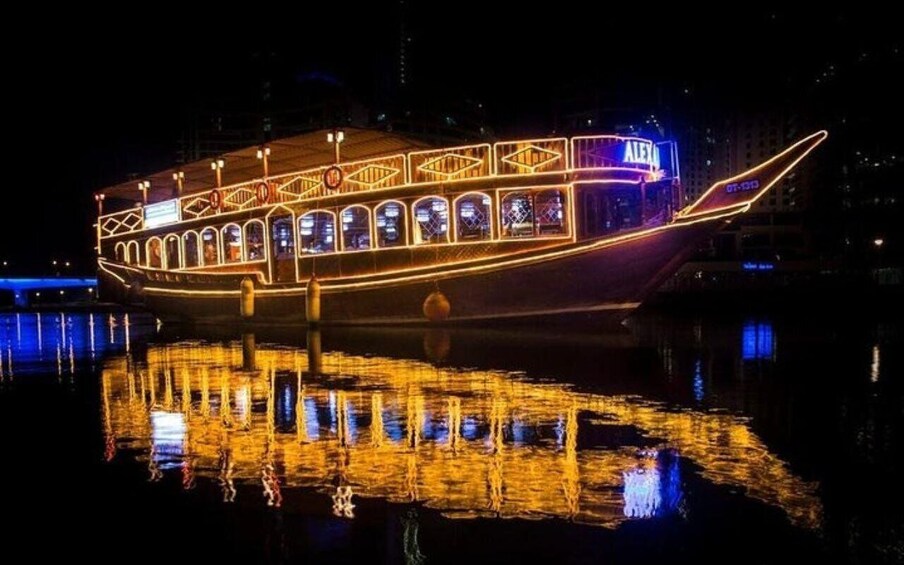 A lit boat with a reflection on the water. 4